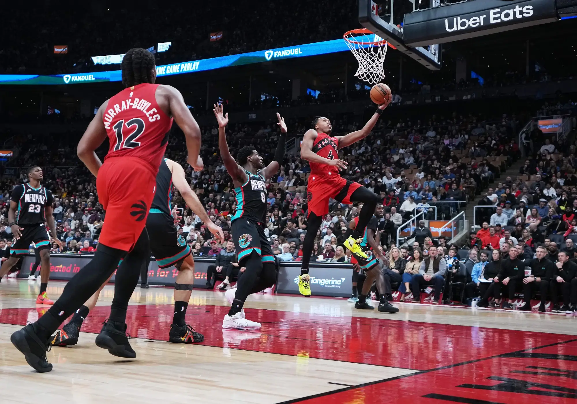 Nov 2, 2025; Toronto, Ontario, CAN; Toronto Raptors forward Scottie Barnes (4) drives to the basket as Memphis Grizzlies forward Jaren Jackson Jr. (8) tries to defend during the fourth quarter at Scotiabank Arena.
