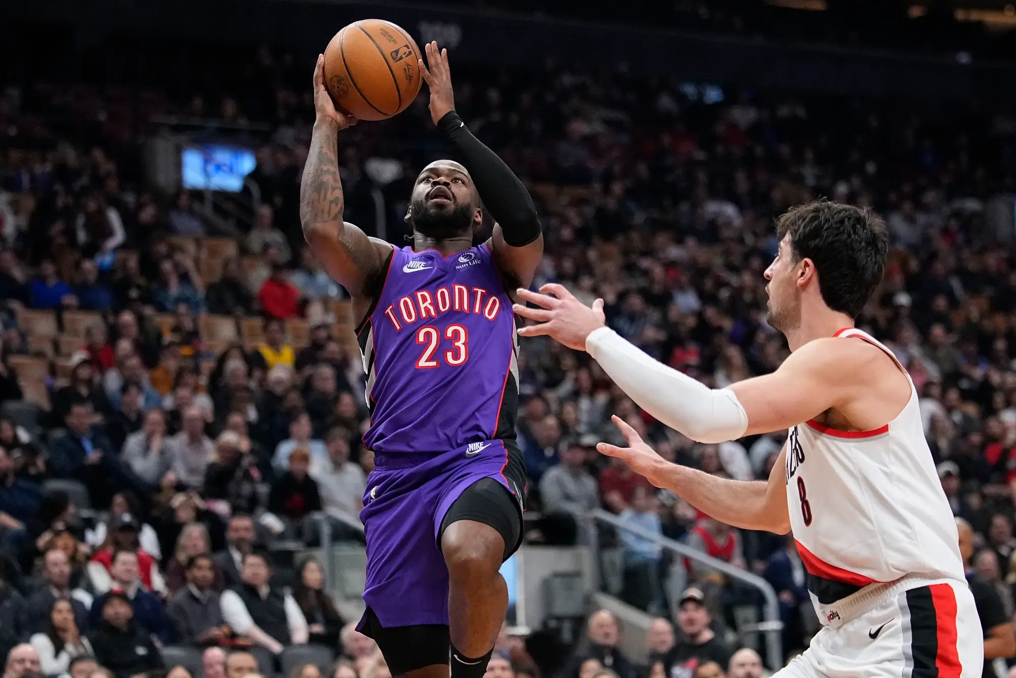 Apr 3, 2025; Toronto, Ontario, CAN; Toronto Raptors guard Jamal Shead (23) goes up to make a basket against Portland Trail Blazers forward Deni Avdija (8) during the first half at Scotiabank Arena. 