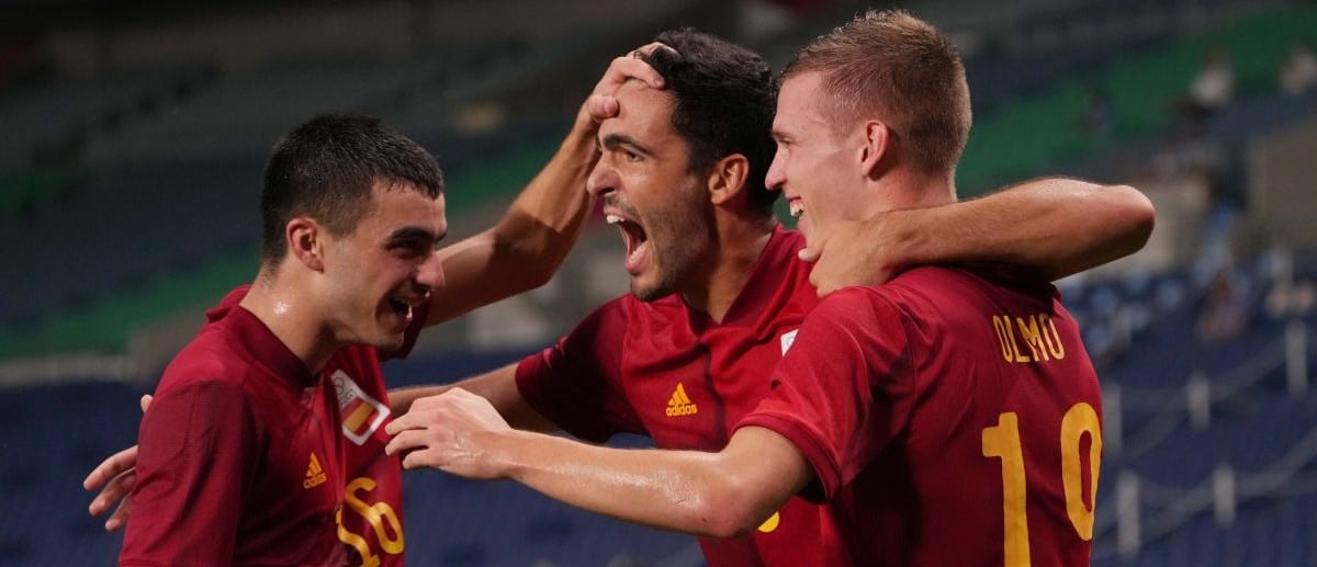 Team Spain midfielder Mikel Merino (8) celebrates with Dani Olmo (19) and Pedri Gonzalez (16) after scoring a goal against Argentina during the Tokyo 2020 Olympic Summer Games at Saitama Stadium