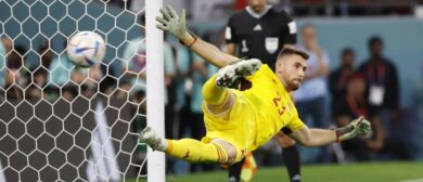 Spain goalkeeper Unai Simon (23) allows a goal scored by Morocco midfielder Hakim Ziyech (7) during penalty kicks in the round of sixteen match of the 2022 FIFA World Cup at Education City Stadium.