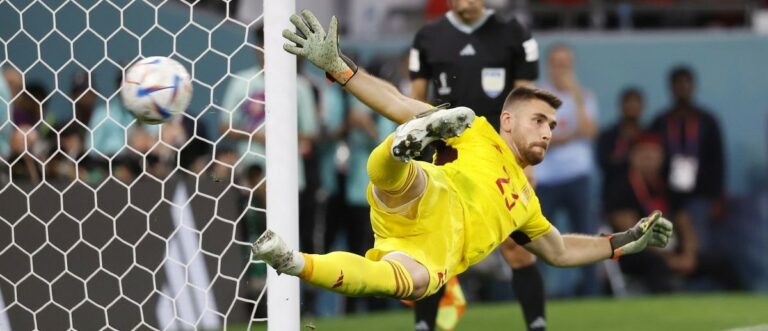 Spain goalkeeper Unai Simon (23) allows a goal scored by Morocco midfielder Hakim Ziyech (7) during penalty kicks in the round of sixteen match of the 2022 FIFA World Cup at Education City Stadium.