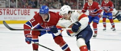 Montreal Canadiens defenseman Kaiden Guhle (21) and Florida Panthers forward Mackie Samoskevich (25) battle for the puck during the first period at the Bell Centre.
