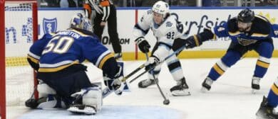 St. Louis Blues goaltender Jordan Binnington (50) and defenseman Nick Leddy (4) defend the net from Utah Hockey Club center Logan Cooley (92) during the third period at Enterprise Center.