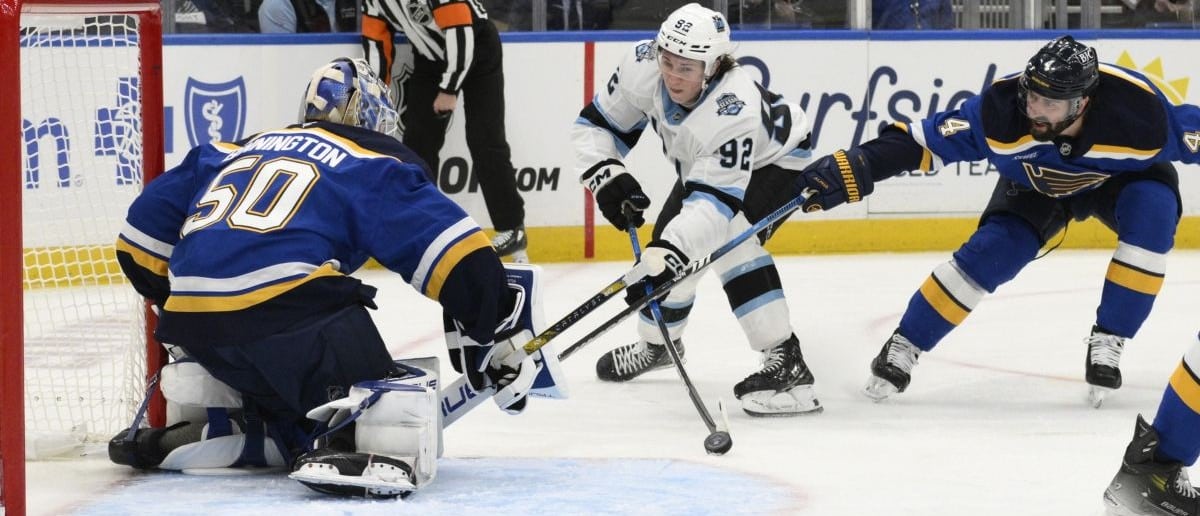 St. Louis Blues goaltender Jordan Binnington (50) and defenseman Nick Leddy (4) defend the net from Utah Hockey Club center Logan Cooley (92) during the third period at Enterprise Center.