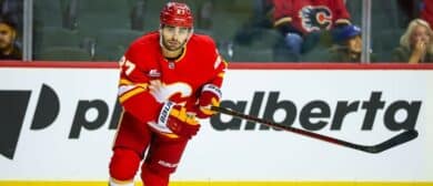 Calgary Flames right wing Matt Coronato (27) skates against the Vancouver Canucks during the first period at Scotiabank Saddledome