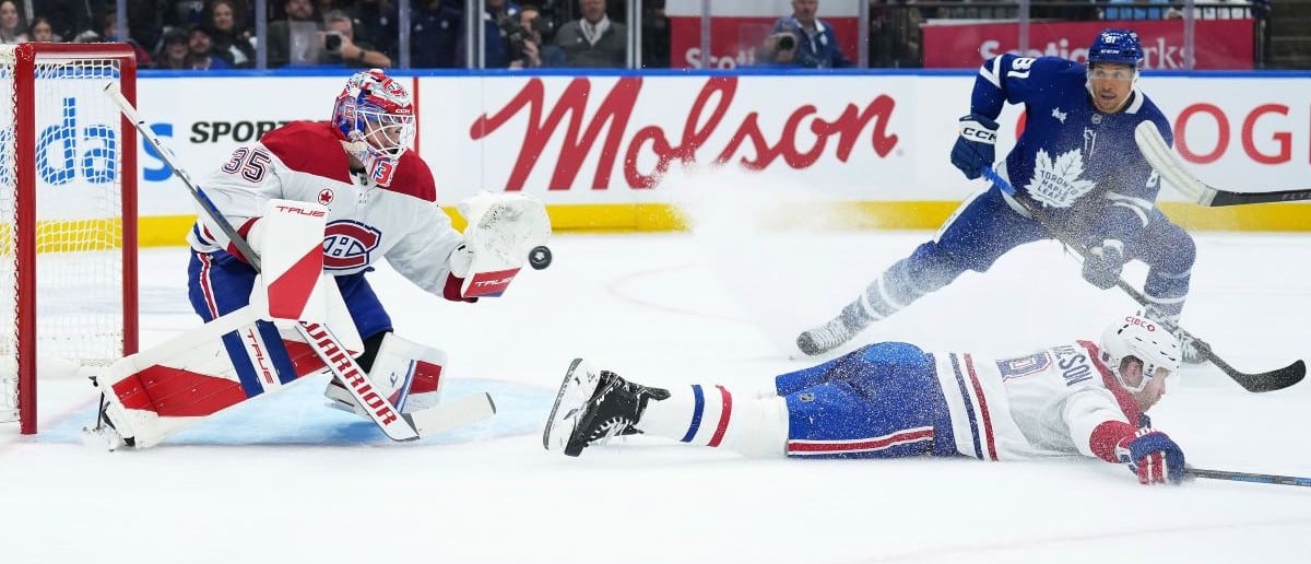 Montreal Canadiens goaltender Sam Montembeault (35) stops the puck as Toronto Maple Leafs center Dakota Joshua (81) looks for the rebound during the first period at Scotiabank Arena.