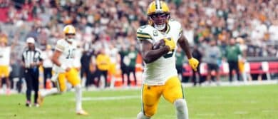 Green Bay Packers running back Josh Jacobs (8) runs for a touchdown against the Arizona Cardinals during the second half at State Farm Stadium