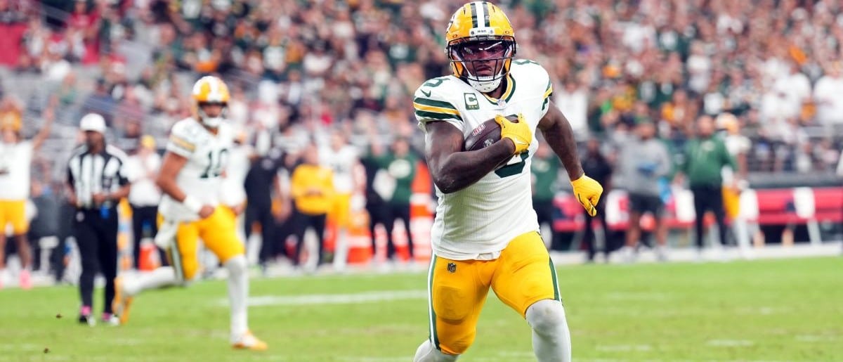 Green Bay Packers running back Josh Jacobs (8) runs for a touchdown against the Arizona Cardinals during the second half at State Farm Stadium