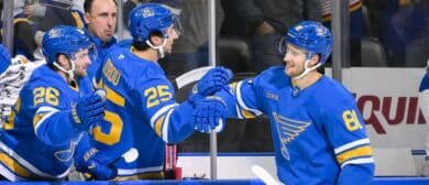 St. Louis Blues left wing Dylan Holloway (81) is congratulated by right wing Jordan Kyrou (25) and left wing Nathan Walker (26) after scoring against the Vancouver Canucks during the first period at Enterprise Center
