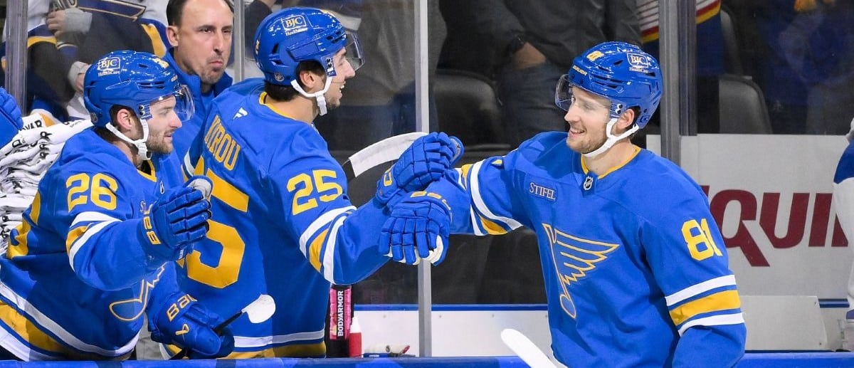 St. Louis Blues left wing Dylan Holloway (81) is congratulated by right wing Jordan Kyrou (25) and left wing Nathan Walker (26) after scoring against the Vancouver Canucks during the first period at Enterprise Center