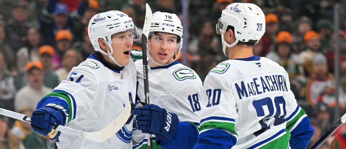 Vancouver Canucks forward Drew O'Connor (18) celebrates his goal against the Minnesota Wild with forward Aatu Raty (54) and forward Mackenzie MacEachern during the third period at Grand Casino Arena