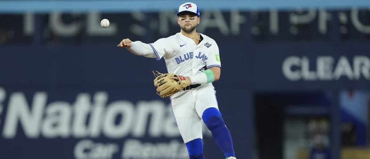 Toronto Blue Jays designated hitter Bo Bichette (11) throws to first for an out against Los Angeles Dodgers right fielder Teoscar Hernandez (37) in the eighth inning during game seven of the 2025 MLB World Series at Rogers Centre