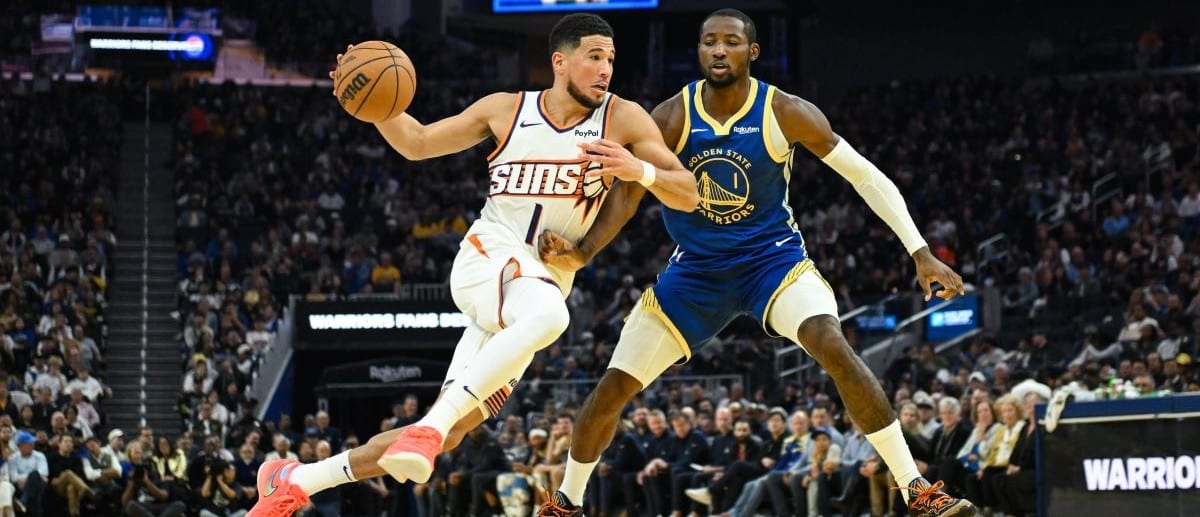 Phoenix Suns guard Devin Booker (1) drives to the basket against Golden State Warriors forward Jonathan Kuminga (1) in the second quarter at Chase Center
