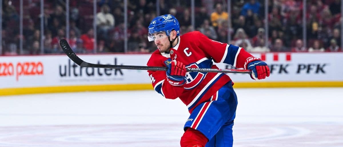 Montreal Canadiens center Nick Suzuki (14) tracks his shot against the Los Angeles Kings during the third period at Bell Centre