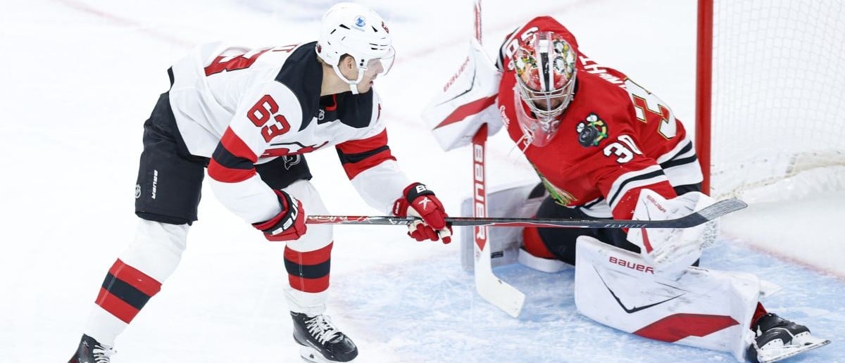 Chicago Blackhawks goaltender Spencer Knight (30) defends against New Jersey Devils left wing Jesper Bratt (63) during the first period at United Center