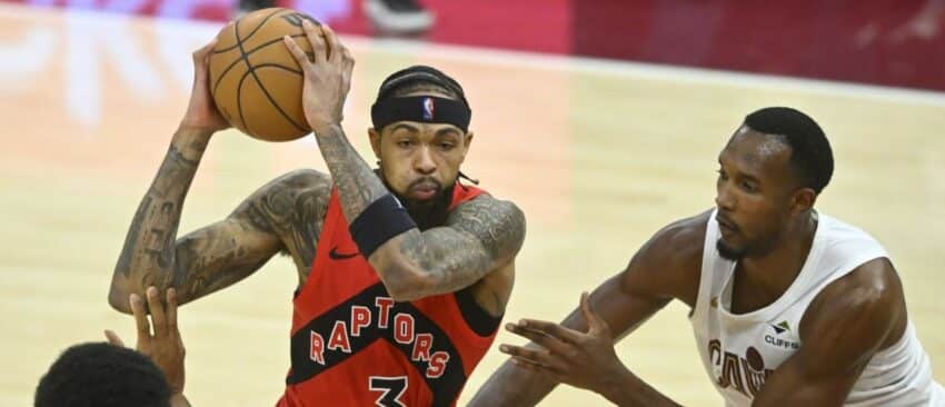 Toronto Raptors forward Brandon Ingram (3) drives between Cleveland Cavaliers center Jarrett Allen (31) and center Evan Mobley (4) in the fourth quarter at Rocket Arena