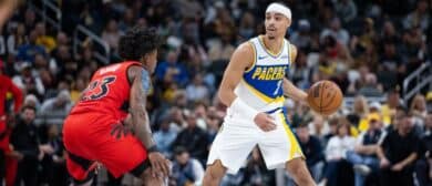 Indiana Pacers guard/forward Andrew Nembhard (2) dribbles the ball while Toronto Raptors guard Jamal Shead (23) defends in the second half at Gainbridge Fieldhouse