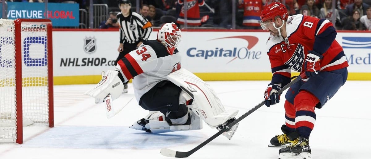 New Jersey Devils goaltender Jake Allen (34) makes a save against on Washington Capitals left wing Alex Ovechkin (8) in a shootout at Capital One Arena.