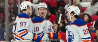 Edmonton Oilers center Connor McDavid (97) left wing Zach Hyman (18) and center Matt Savoie (22) talk Carolina Hurricanes during the second period at Lenovo Center.