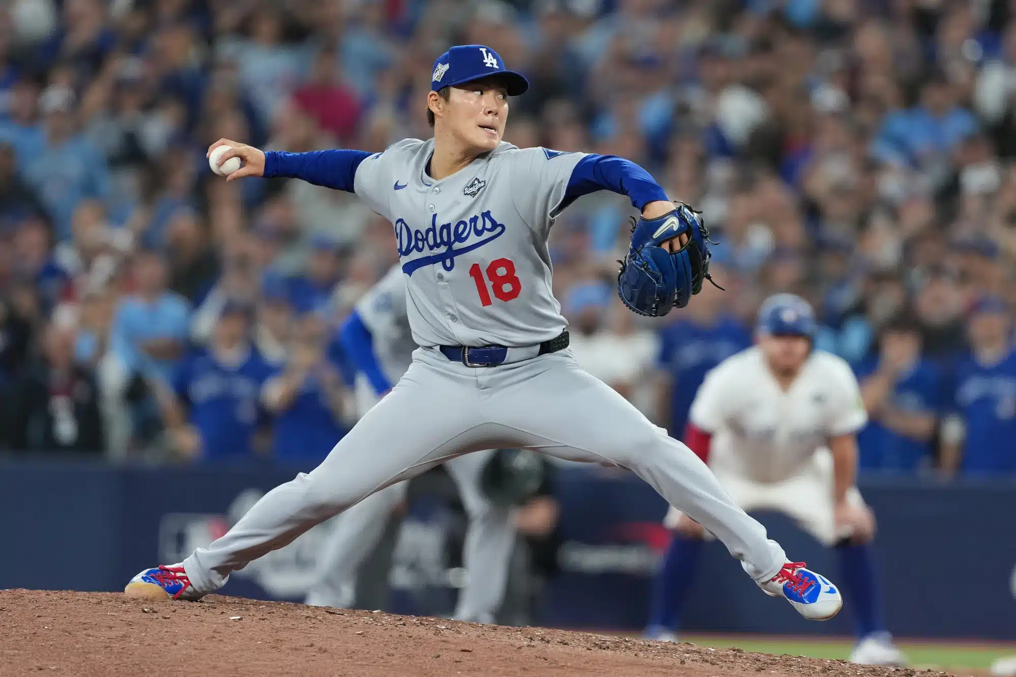 Nov 1, 2025; Toronto, Ontario, CAN; Los Angeles Dodgers pitcher Yoshinobu Yamamoto (18) throws a pitch against the Toronto Blue Jays in the ninth inning for game seven of the 2025 MLB World Series at Rogers Centre.