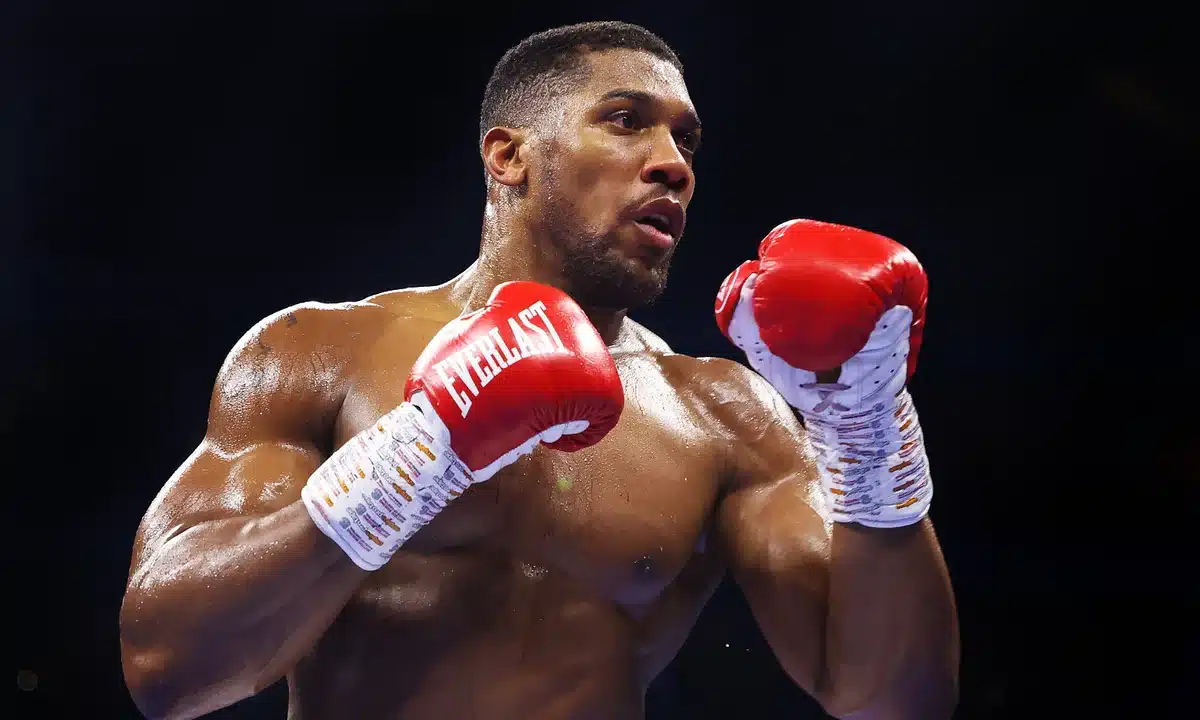 Anthony Joshua wearing boxing gloves in a boxing match
