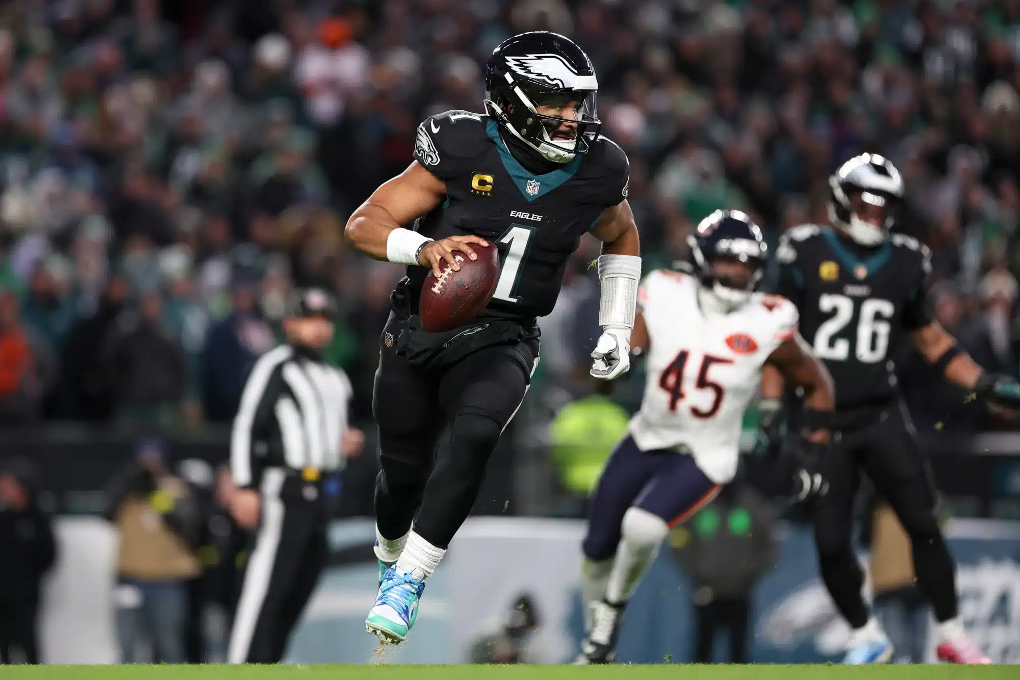 Nov 28, 2025; Philadelphia, Pennsylvania, USA; Philadelphia Eagles quarterback Jalen Hurts (1) scrambles with the ball against the Chicago Bears during the third quarter of the game at Lincoln Financial Field. 