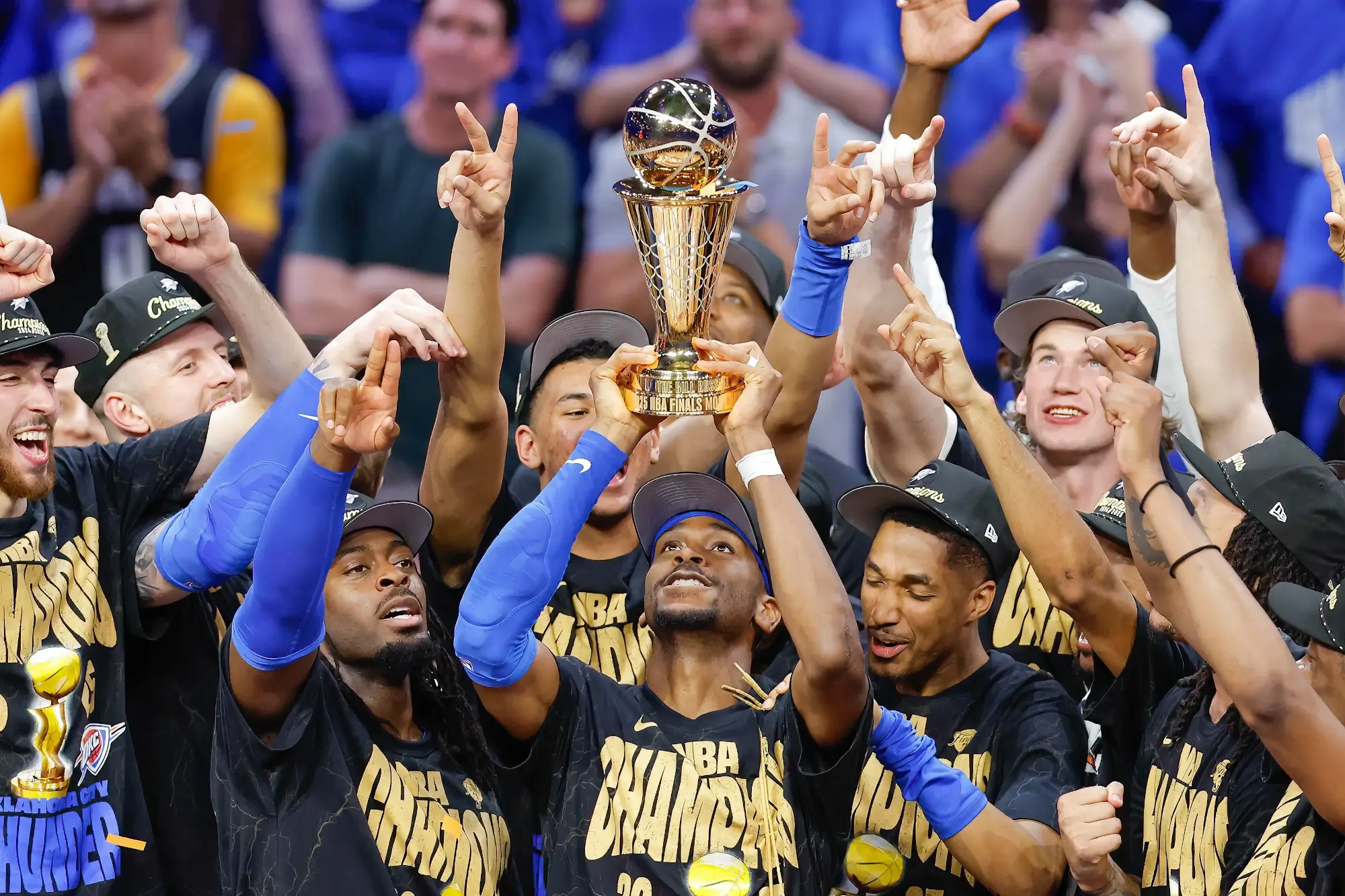 Jun 22, 2025; Oklahoma City, Oklahoma, USA; Oklahoma City Thunder guard Shai Gilgeous-Alexander (2) holds up his NBA Finals Bill Russell MVP trophy at the end of game seven of the 2025 NBA Finals after defeating the Indiana Pacers at Paycom Center. 