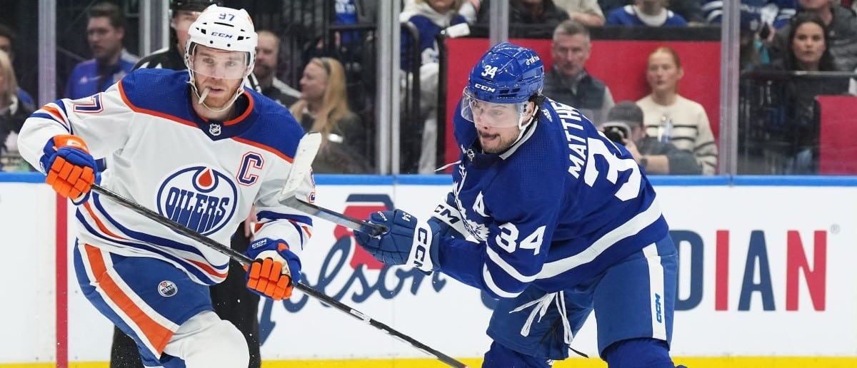 Toronto Maple Leafs center Auston Matthews (34) battles with Edmonton Oilers center Connor McDavid (97) during the first period at Scotiabank Arena