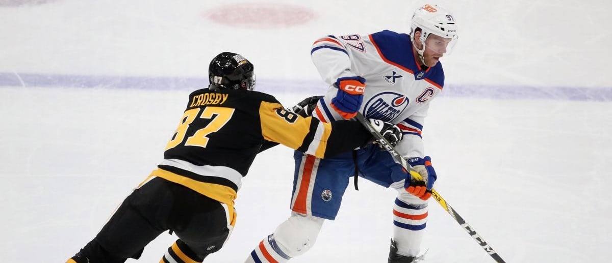 Edmonton Oilers center Connor McDavid (97) skates with the puck as Pittsburgh Penguins center Sidney Crosby (87) defends during the third period at PPG Paints Arena