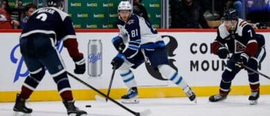 Winnipeg Jets left wing Kyle Connor (81) controls the puck against Colorado Avalanche defenseman Cale Makar (8) and defenseman Devon Toews (7) in the third period at Ball Arena.