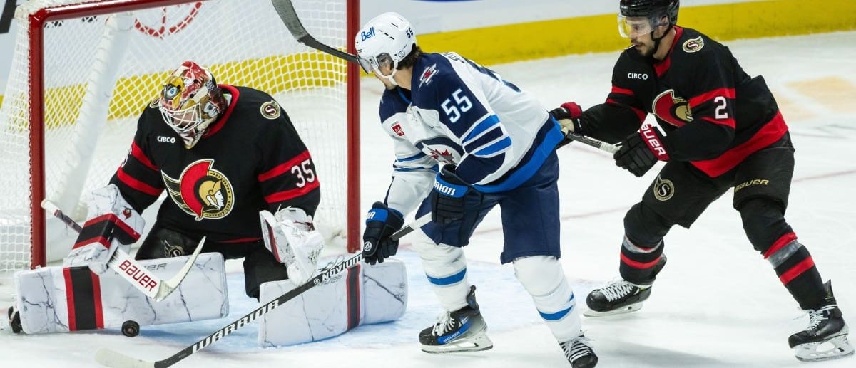 Ottawa Senators goalie Linus Ullmark (35) makes a save in front of Winnipeg Jets center Mark Scheifele (55) as Senators defenseman Artem Zub (2) moves in to defend in the third period at the Canadian Tire Centre.