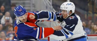 Edmonton Oilers defensemen Josh Brown (44) and Winnipeg Jets defensemen Tyrel Bauer (77) fight during the second period at Rogers Place.