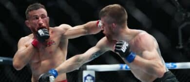 Merab Dvalishvili (red gloves) fights Cory Sandhagen (blue gloves) during UFC 320 at T-Mobile Arena