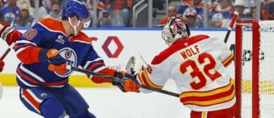 Calgary Flames goaltender Dustin Wolf (32) makes a save on a shot by Edmonton Oilers forward Trent Frederic (10) during the first period at Rogers Place.