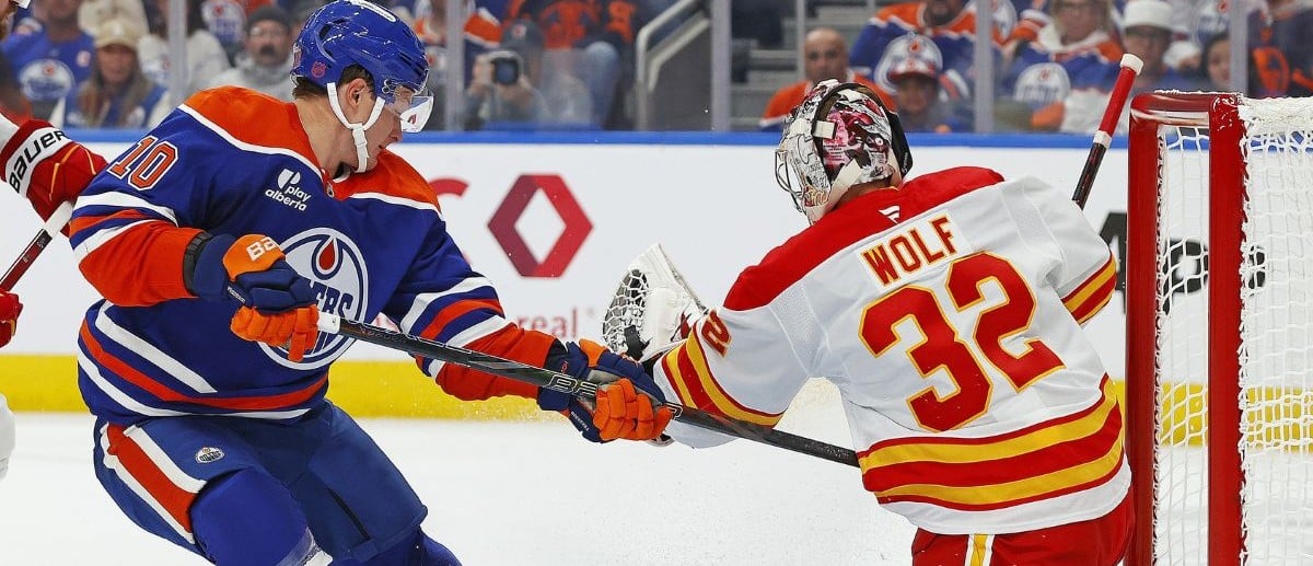Calgary Flames goaltender Dustin Wolf (32) makes a save on a shot by Edmonton Oilers forward Trent Frederic (10) during the first period at Rogers Place.