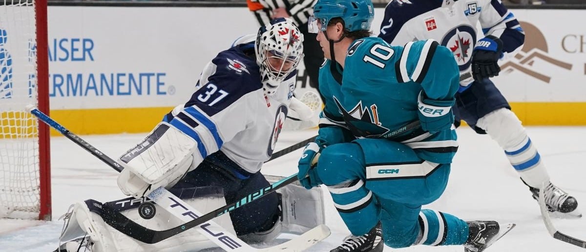 Winnipeg Jets goalie Connor Hellebuyck (37) makes a save and defenseman Dylan DeMelo (2) watches the play against San Jose Sharks center Ty Dellandrea (10) during the second period at SAP Center at San Jose.
