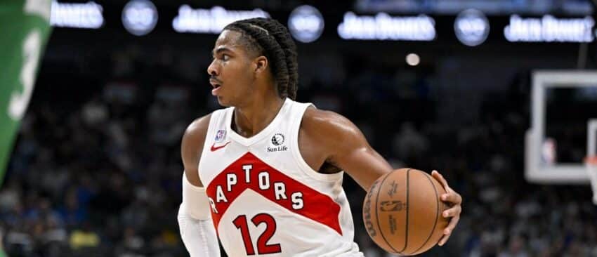 Toronto Raptors forward Collin Murray-Boyles (12) brings the ball up court during the game between the Mavericks and the Raptors at the American Airlines Center.