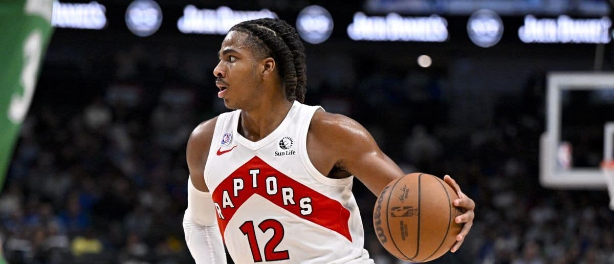Toronto Raptors forward Collin Murray-Boyles (12) brings the ball up court during the game between the Mavericks and the Raptors at the American Airlines Center.