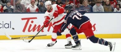 Detroit Red Wings right wing Alex DeBrincat (93) wrists a shot on goal over the stick of Columbus Blue Jackets defenseman Damon Severson (78) during the first period at Nationwide Arena.