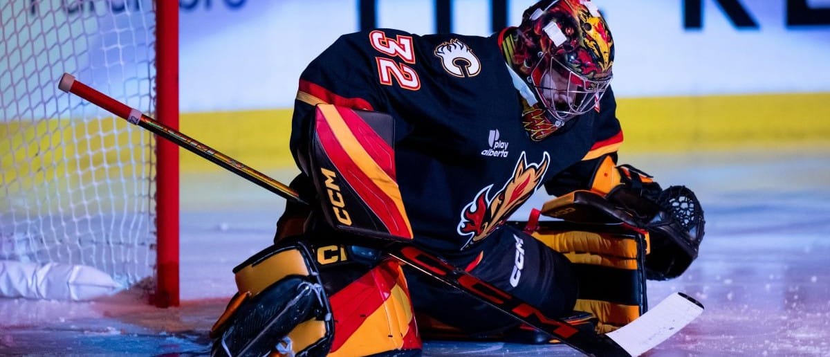 Calgary Flames goaltender Dustin Wolf (32) stretches ahead of the first period against the Utah Mammoth at Scotiabank Saddledome.