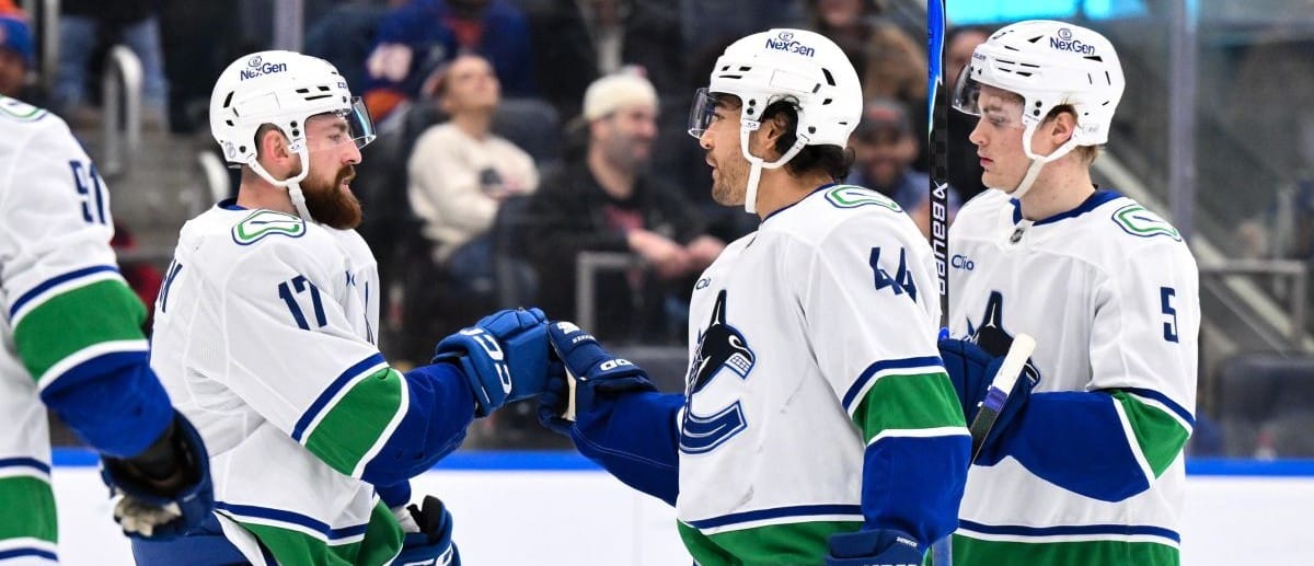 Vancouver Canucks left wing Kiefer Sherwood (44) celebrates with teammates after scoring a goal against the New York Islanders during the first period at UBS Arena.