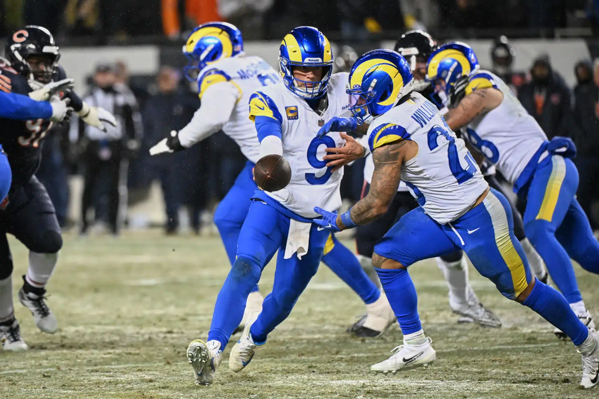 Jan 18, 2026; Chicago, IL, USA; Los Angeles Rams quarterback Matthew Stafford (9) hands the ball to running back Kyren Williams (23) against the Chicago Bears during the fourth quarter of an NFC Divisional Round game at Soldier Field.