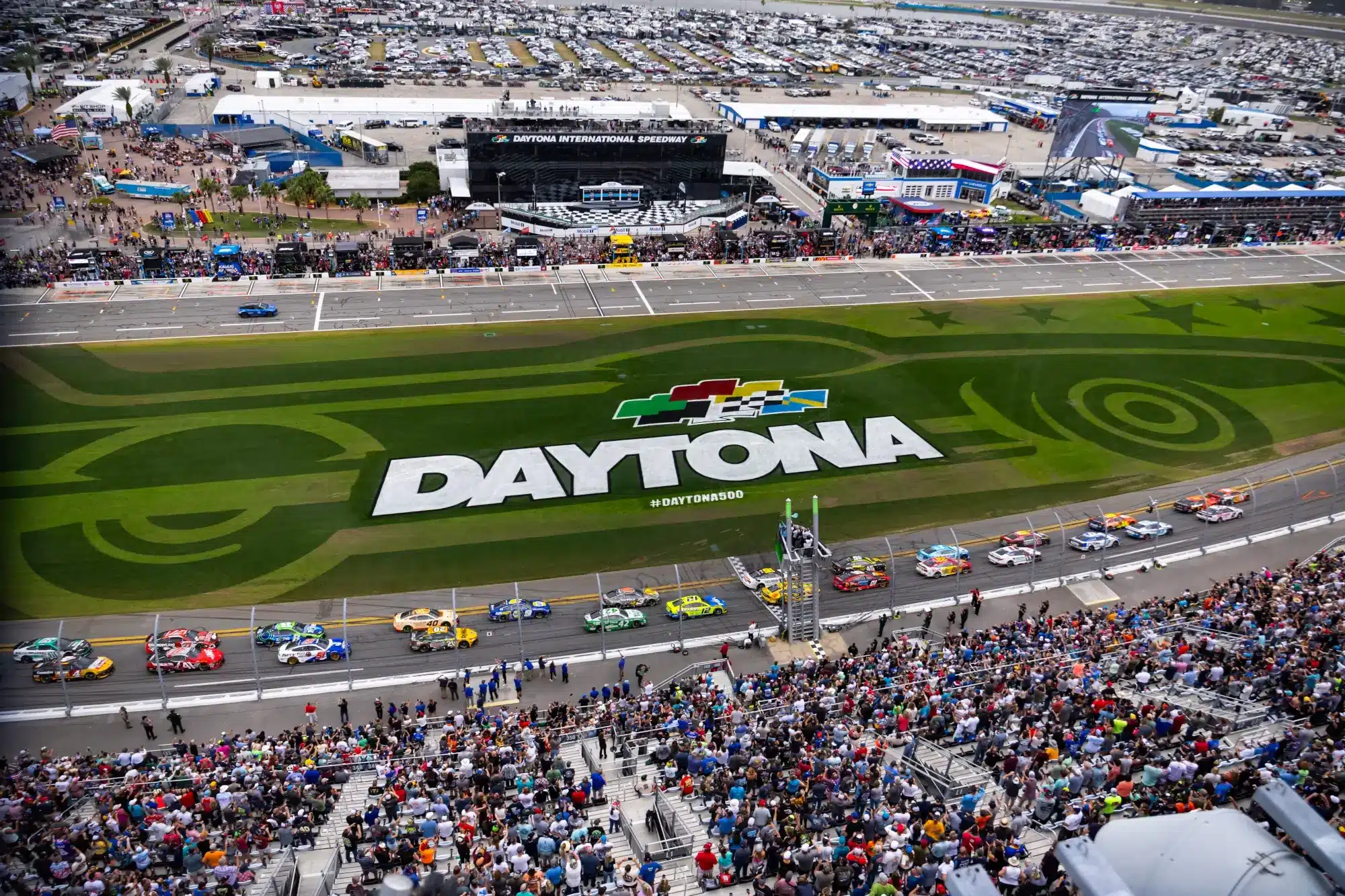 Feb 16, 2025; Daytona Beach, Florida, USA; NASCAR Cup Series driver Austin Cindric (2) and driver Chase Briscoe (19) lead the field at the green flag to start the Daytona 500 at Daytona International Speedway.