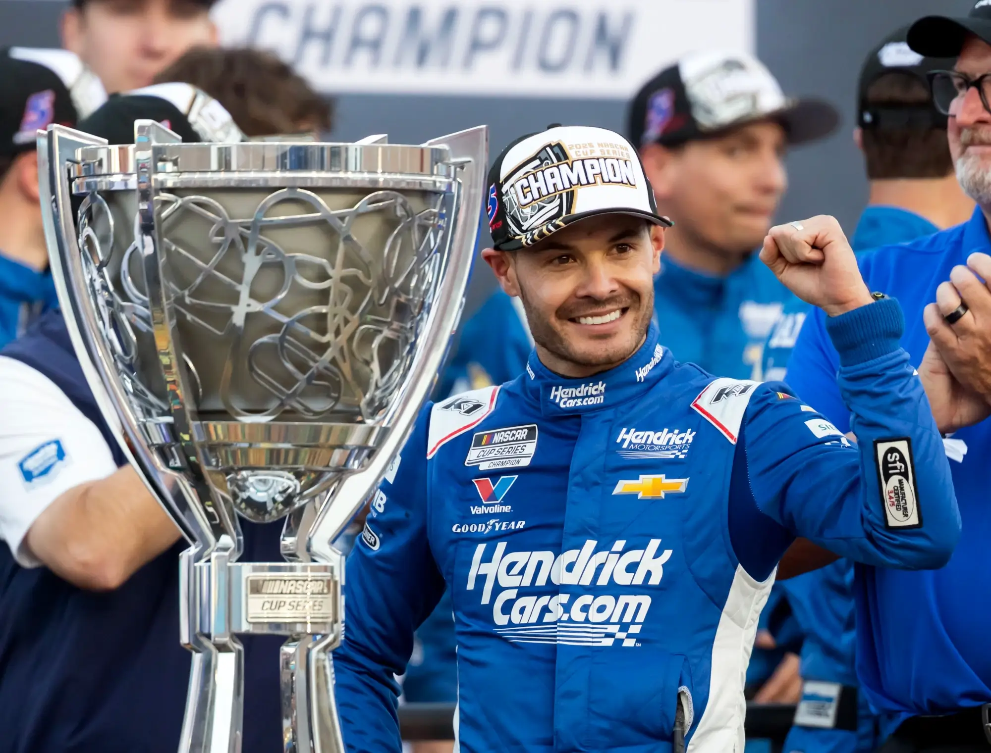 Nov 2, 2025; Avondale, Arizona, USA; NASCAR Cup Series driver Kyle Larson (5) celebrates with the Bill France Cup trophy after clinching the 2025 NASCAR Cup Series Championship following the NASCAR Championship race at Phoenix Raceway.