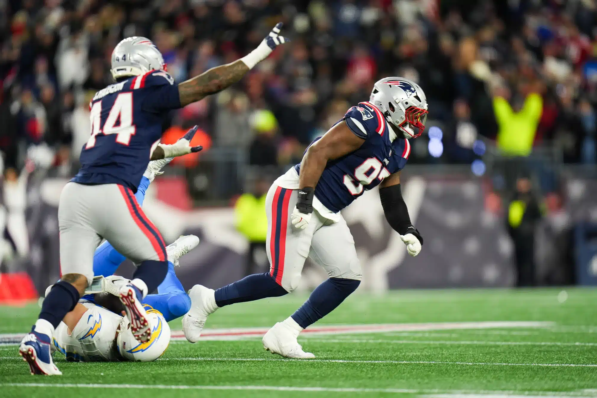 Jan 11, 2026; Foxborough, MA, USA; New England Patriots defensive end Milton Williams (97) and New England Patriots linebacker K'lavon Chaisson (44) celebrate a sack during the fourth quarter against the Los Angeles Chargers in an AFC Wild Card Round game at Gillette Stadium.