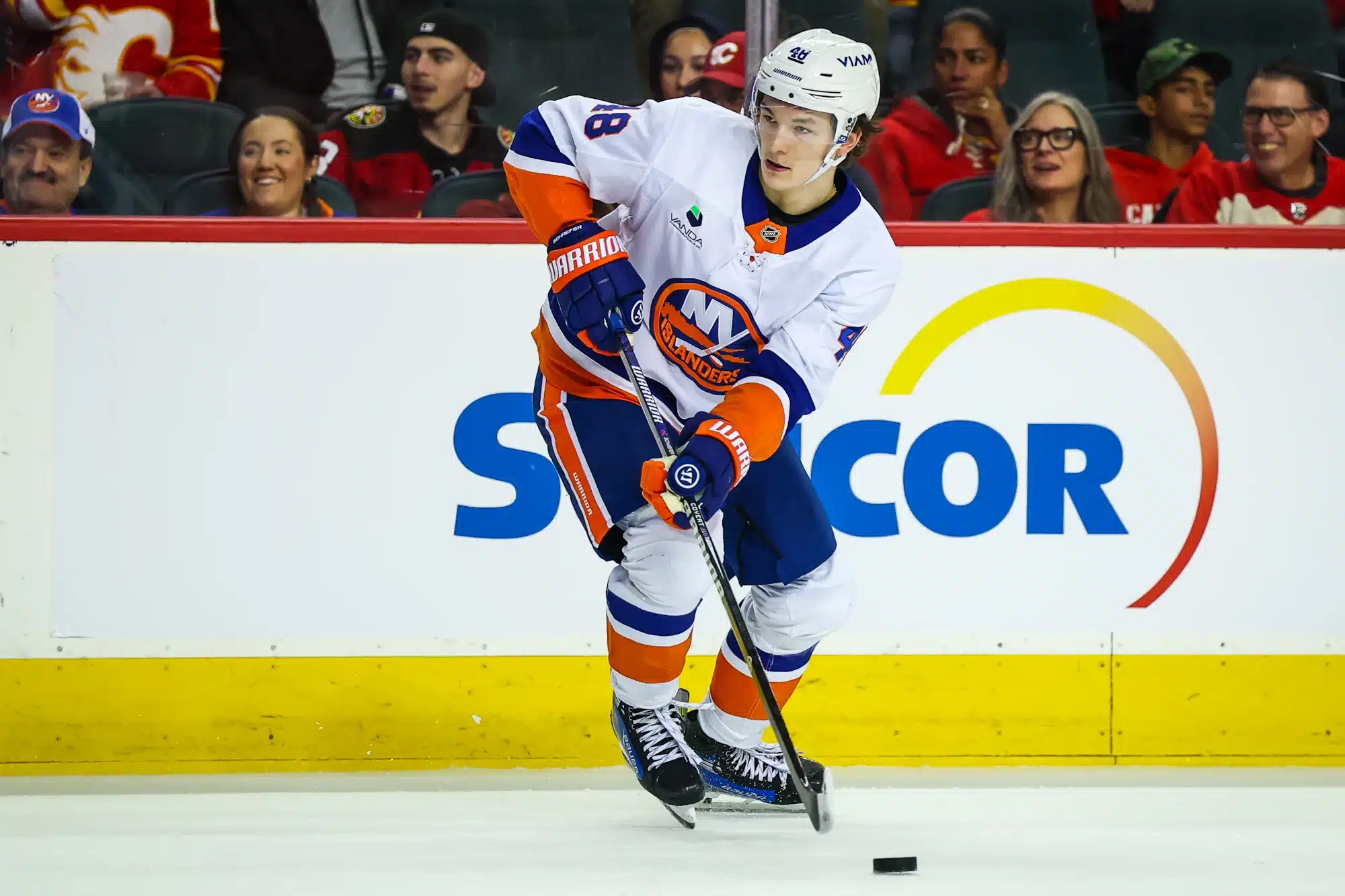 Jan 17, 2026; Calgary, Alberta, CAN; New York Islanders defenseman Matthew Schaefer (48) skates with the puck against the Calgary Flames during the third period at Scotiabank Saddledome.