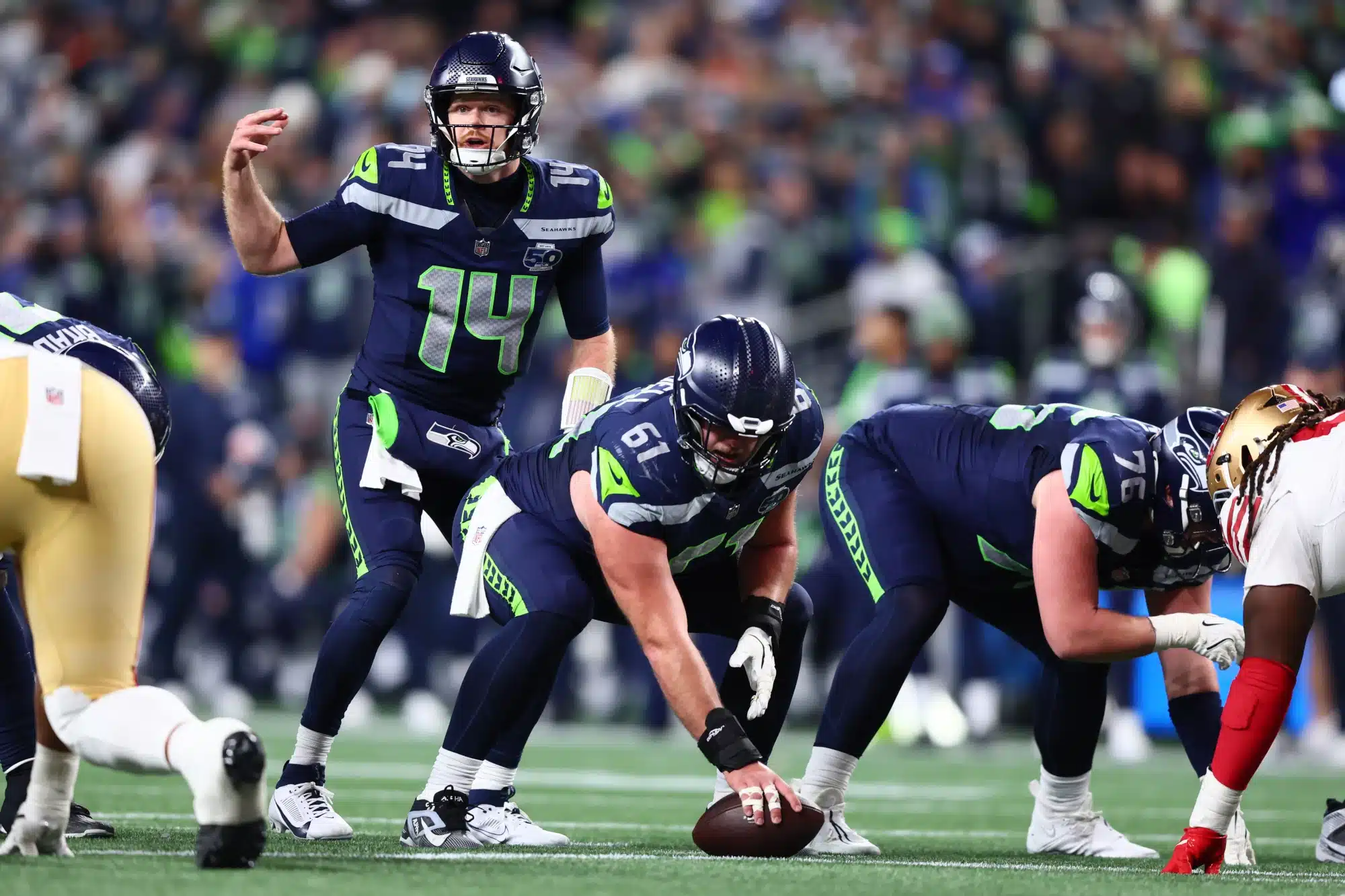 Jan 17, 2026; Seattle, WA, USA; Seattle Seahawks quarterback Sam Darnold (14) under center against the San Francisco 49ers during the second half in an NFC Divisional Round game at Lumen Field.