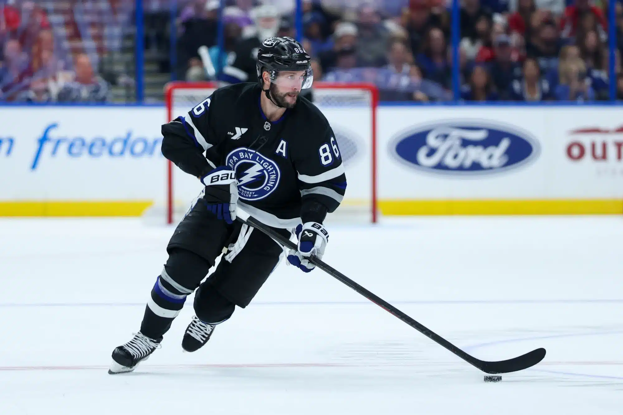 Nov 8, 2025; Tampa, Florida, USA; Tampa Bay Lightning right wing Nikita Kucherov (86) controls the puck against the Washington Capitals in the third period at Benchmark International Arena.