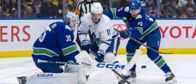 Vancouver Canucks defenseman Elias Pettersson (25) watches as goalie Thatcher Demko (35) makes a save on Toronto Maple Leafs forward Max Domi (11) in the first period at Rogers Arena