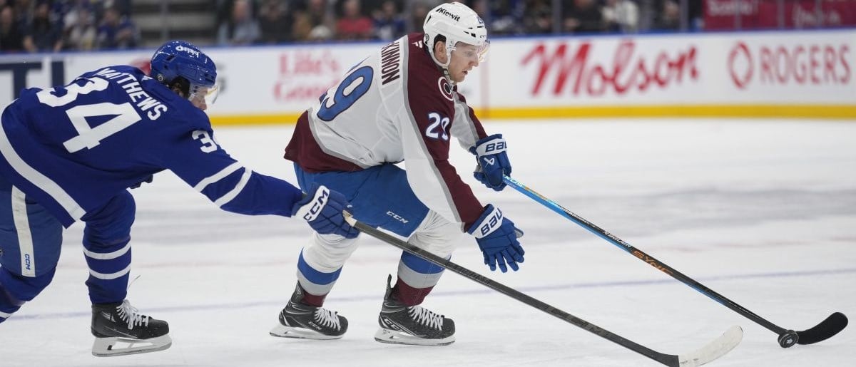 Colorado Avalanche forward Nathan MacKinnon (29) carry the puck past Toronto Maple Leafs forward Auston Matthews (34) during the second period at Scotiabank Arena